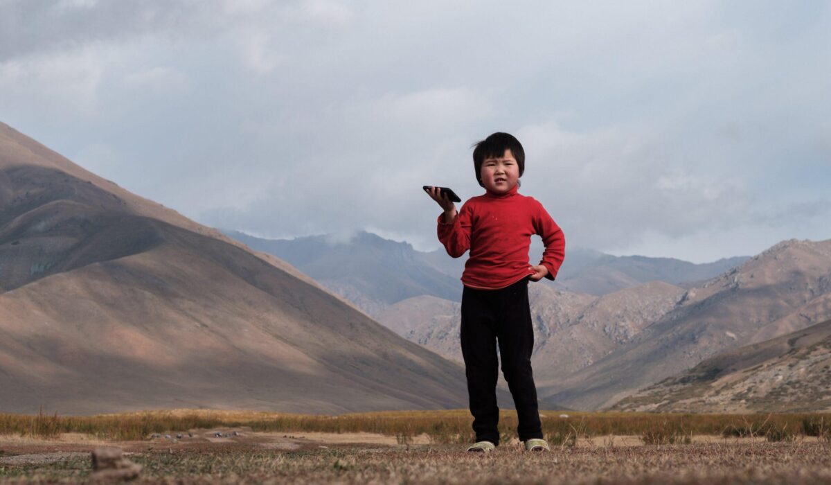 Talant Sultanov Kyrgyzstan, 2018, Rayana Imankulova (4), pictured on 13 September 2018, lives with her parents Akylbek Imankulov (46) and Gulzat Raimbekova (43) in the rangelands of Tokoilu in the Suusamyr Valley, which lies above 2000m in the Tian Shan Mountains in Kyrgyzstan. She loves to watch cartoons on her parents smartphone. Before a Suusamyr Net community network repeater tower was erected right next to her familys small corrugated iron home, they had to buy expensive and unreliable mobile data packages that were quickly exhausted. But now the family has free WiFi in exchange for looking after the tower equipment, and Rayana can watch her favorite cartoons non-stop  she particularly loves the Russian series Masha and the Bear. The one where the rabbits ate all the carrots and potatoes and Masha had to spank them is the best, she says. However, the new WiFi connection recently stopped working for three days due to an electrical fault and Rayana could not watch her cartoons. There was no WiFi so I threw pillows around! she says, pouting. [Photo: Nyani Quarmyne / Text: Laura Salm-Reifferscheidt]