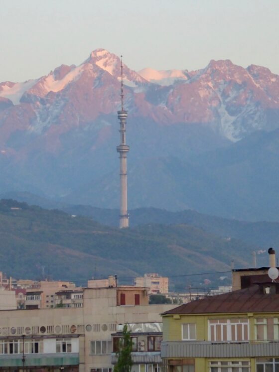 Almaty city landscape with mountains, houses and a TV tower