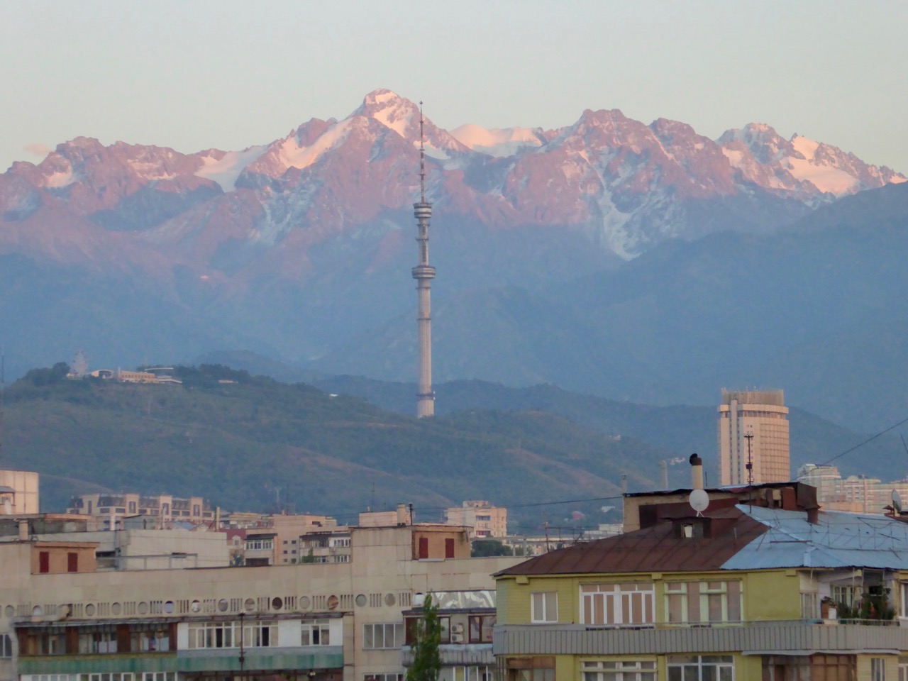 Almaty city landscape with mountains, houses and a TV tower