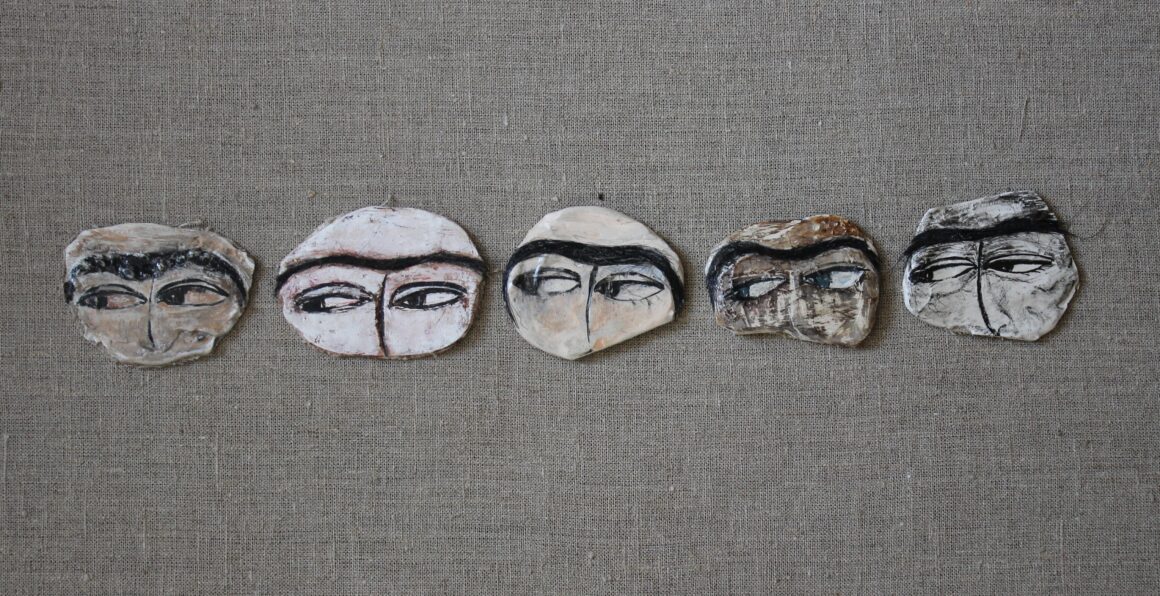 Pins depicting Uyghur women eyes