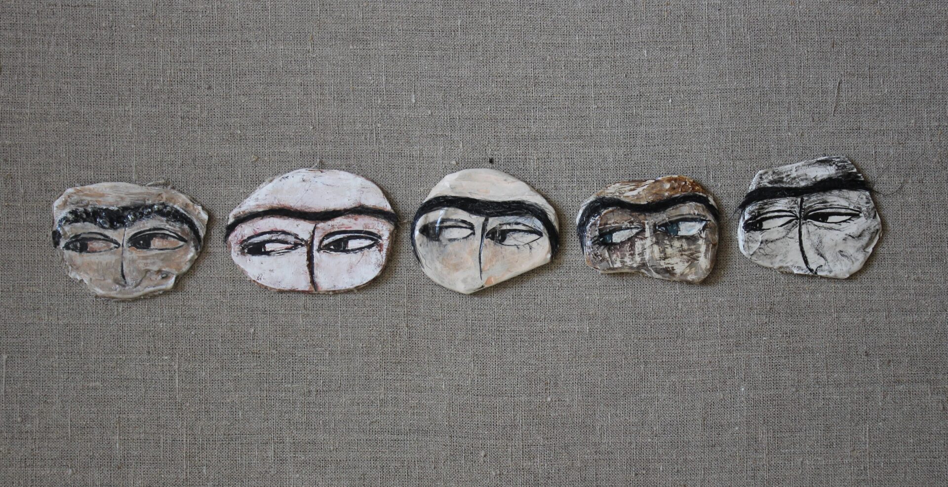 Pins depicting Uyghur women eyes