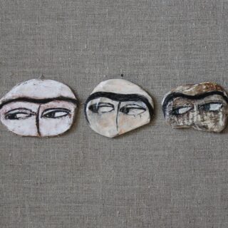 Pins depicting Uyghur women eyes