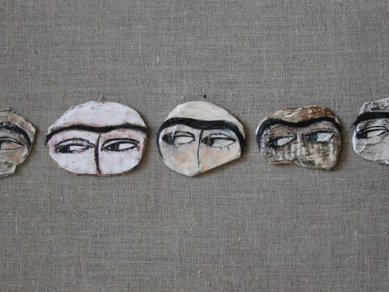 Pins depicting Uyghur women eyes