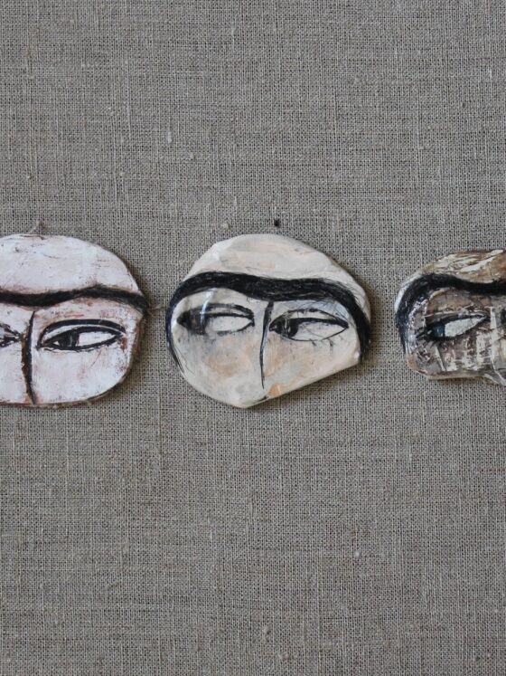 Pins depicting Uyghur women eyes